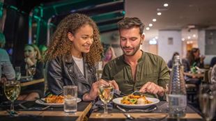 Un couple déguste un repas à bord d'une croisière sur la Tamise à Londres