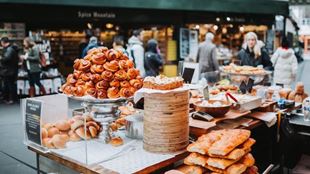 A stall at borough market covered in sweet pastries. 