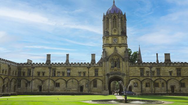Inside Christchurch College, Tom Court and its tower stand in one of the courtyards surrounded by greenery.
