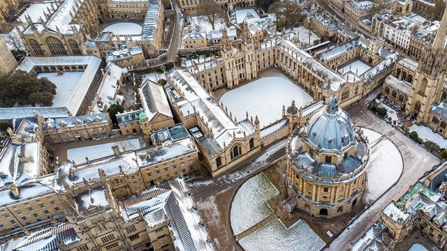 Aerial view of Radcliffe Camera at Bodleian Library the University grounds of Oxford in the background all covered in a little snow.