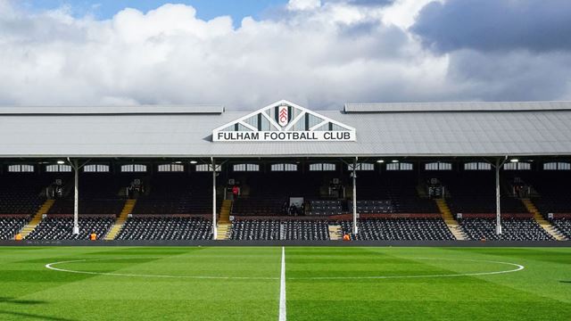 Football pitch and stands at Fulham Football Club’s historic Craven Cottage stadium.