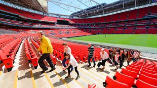 Tour guide and guests walking up the steps at Wembley Stadium.
