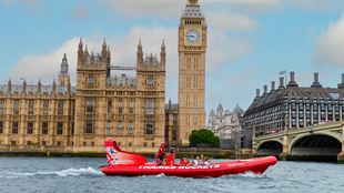 Thames rockets boat passing Big Ben on the river Thames.