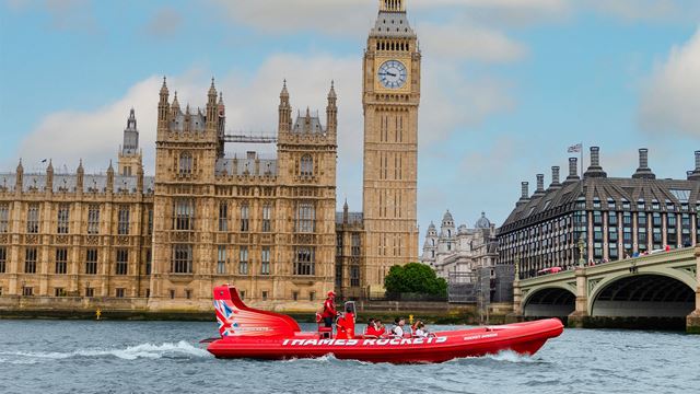 Thames rockets boat passing Big Ben on the river Thames.