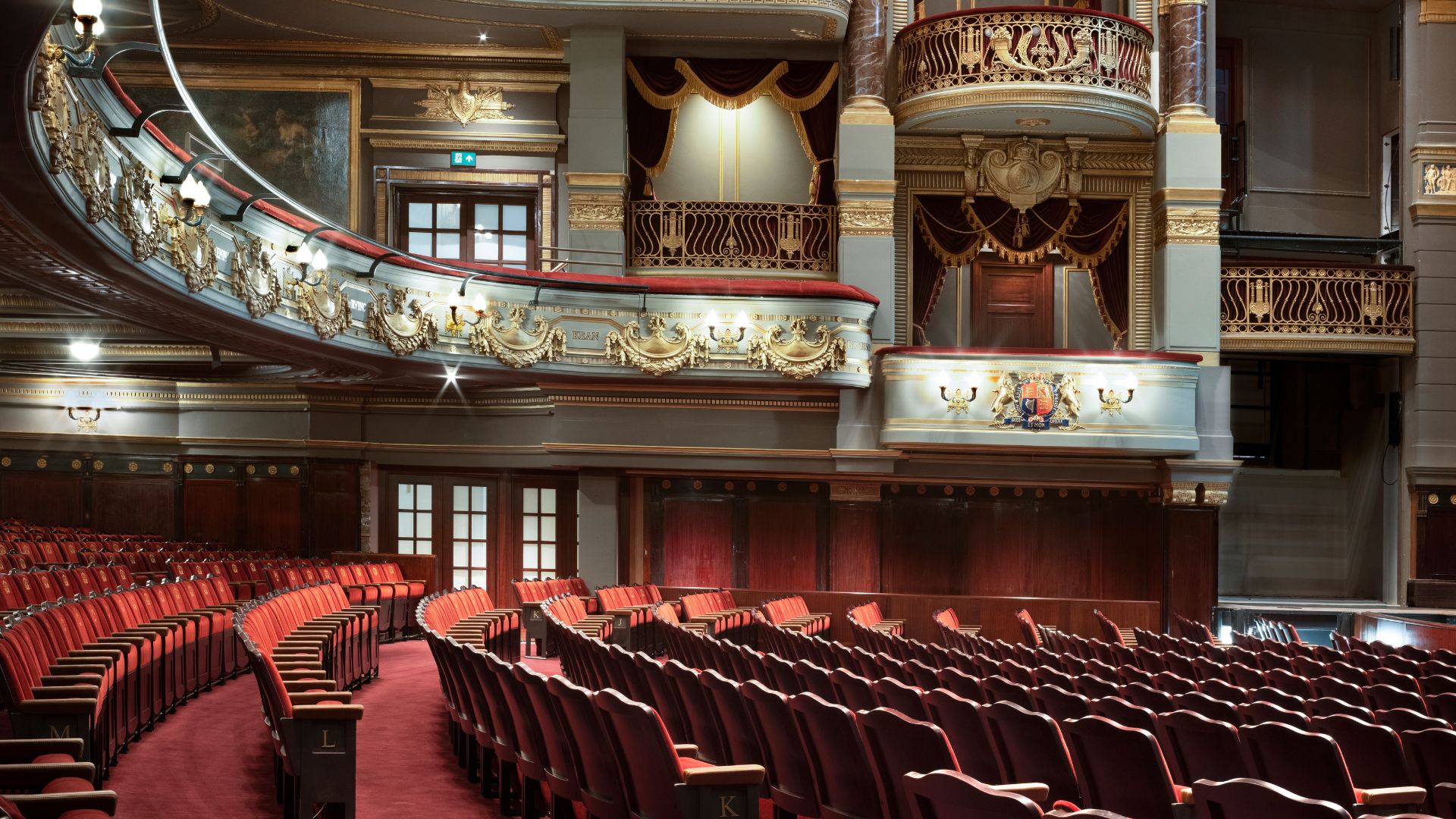 Red seats and ornate blue interiors of the theatre royal drury lane hotel