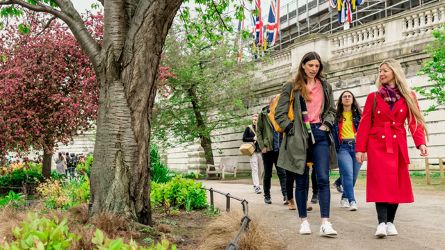 See the iconic Buckingham Palace from St James's Park, as you follow your guide on this royal London tour. Image © visitlondon.com. Two women following a path in St James's Park as part of the Royal Walking Tour in London.