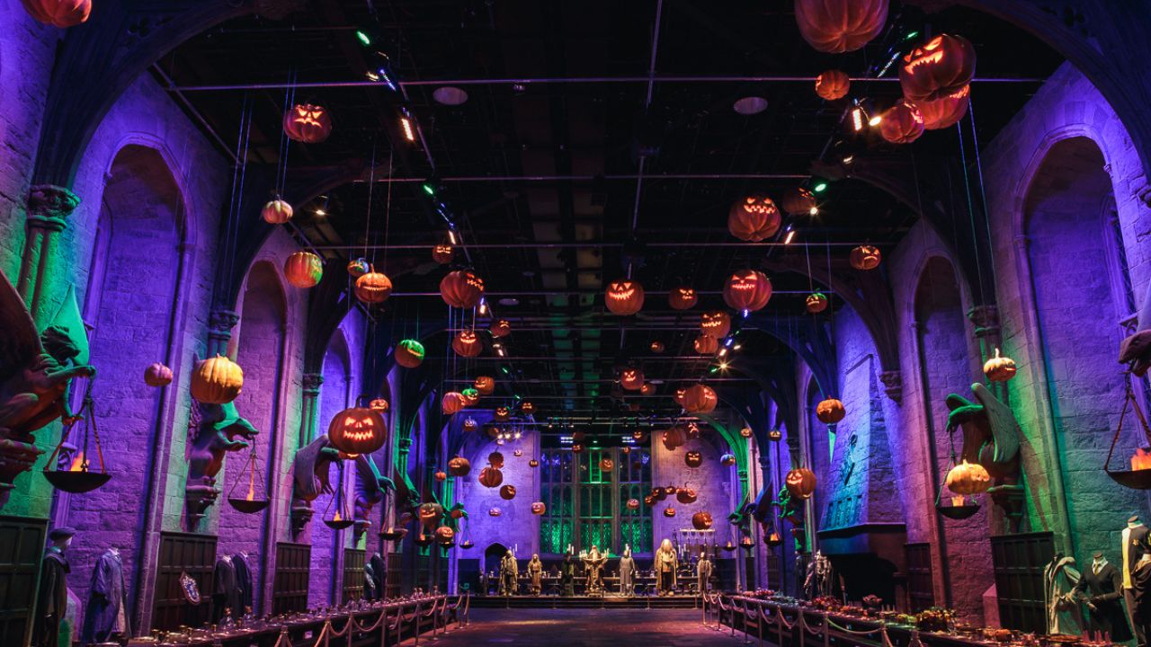 Es ist Halloween in Hogwarts und Sie sind eingeladen, die Ausstellung der Dunklen Künste zu erkunden. TM & © Warner Bros. Entertainment Inc. Harry Potter Publishing Rights © JKR. Schwebende Kürbisse über den Tischen der großen Halle von Hogwarts auf der Warner Bros. Studio Tour.