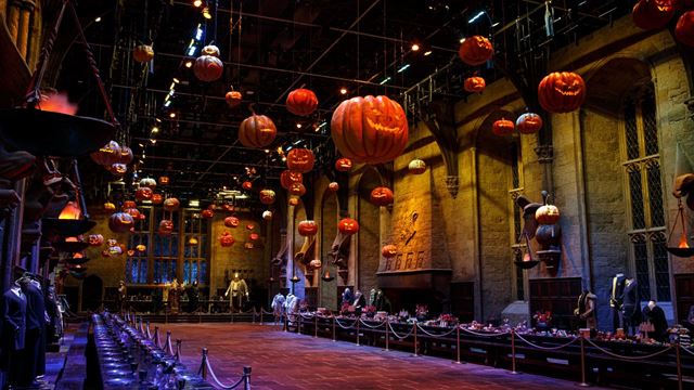 A grand hall with floating pumpkins at the harry potter warner bros studio tour