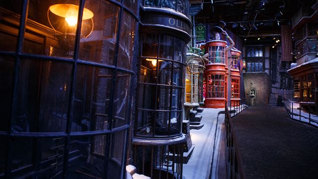 Diagon Alley shops with snow on the road.
