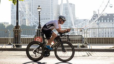 A cyclist passes the iconic London eye on their way around the city track. Image courtesy of OCD Studios.