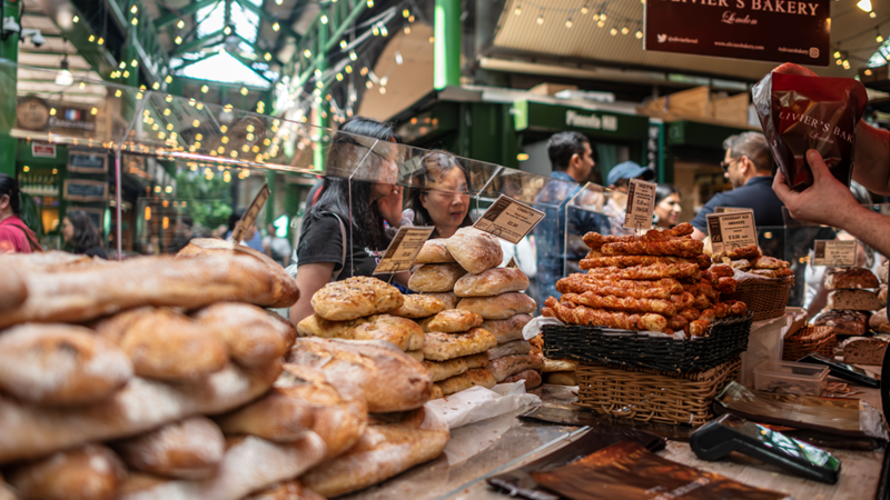 Search for locally sourced goods at Borough Market. Credit: Michael Barrow. Image courtesy of London & Partners. Stacks of freshly baked bread and goodies at a Borough Market stall