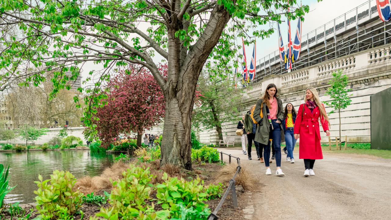 A group walking along a river bank on a Royal walking tour
