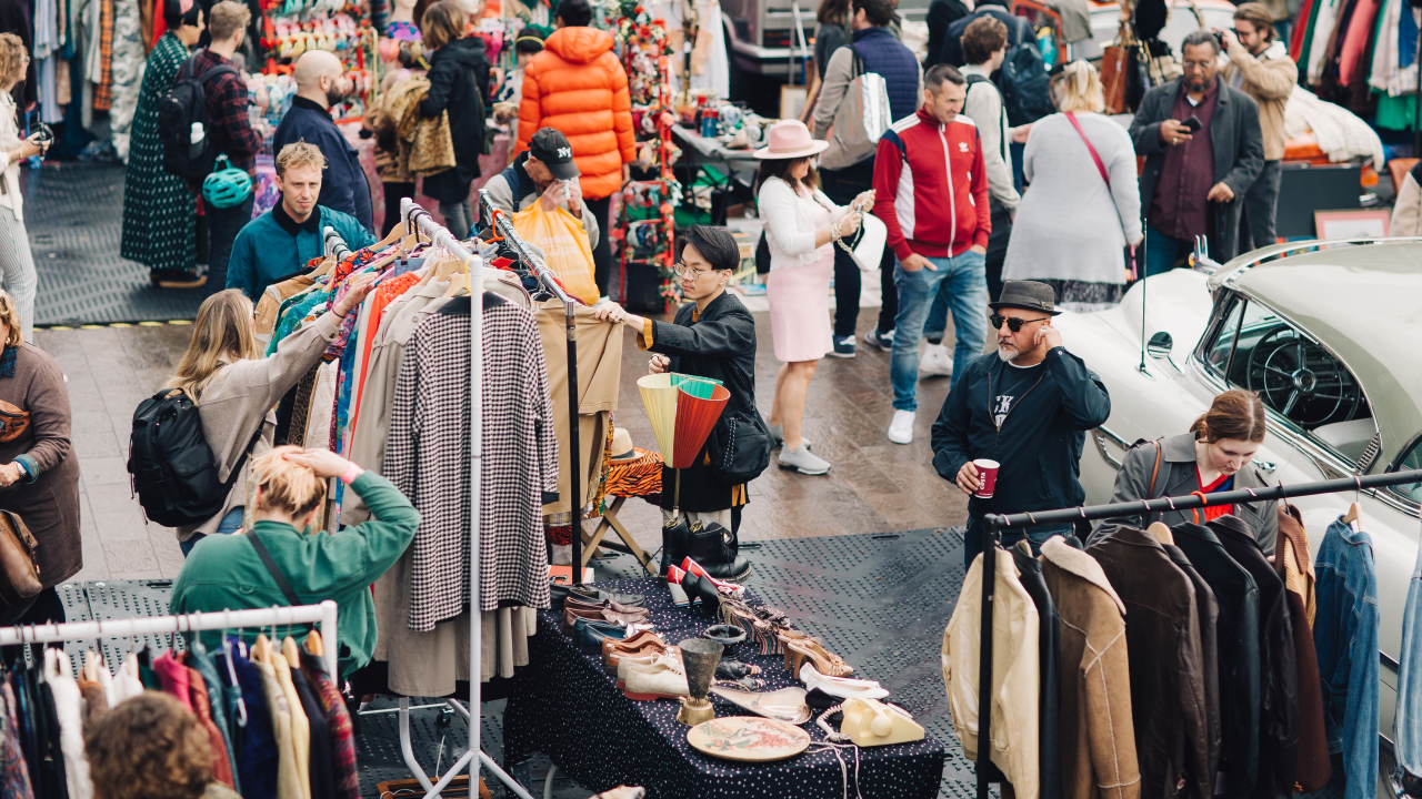 People browsing clothes and trinkets at a vintage market