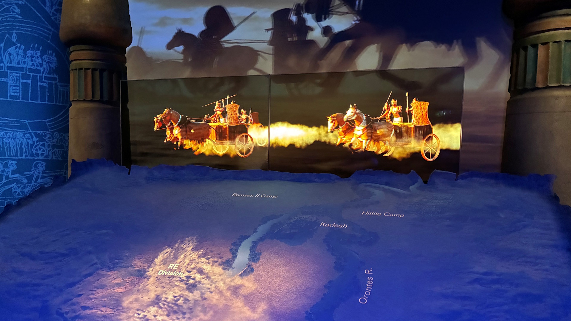 Experience the Battle of Kadesh through immersive displays. © London & Partners / Jonny Payne. Digital displays telling the story of the Battle of Kadesh in the foreground as a map, the midground as action and the background as silhouettes.