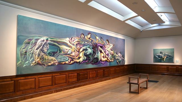 Exhibition room with Sara Shamma's artwork of vibrant painting on wall.