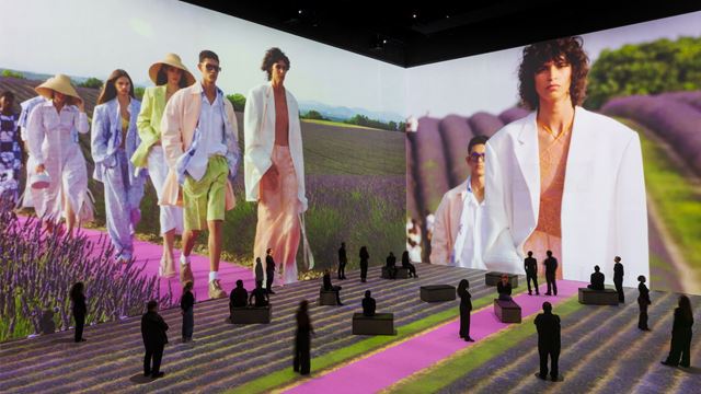 Models walking through lavender field at Jacquemus Spring 2020 show projected on walls at Lightroom.