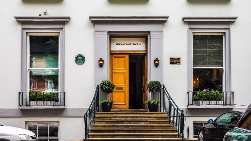 Stop at famous musical hotspots such as Abbey Road Studios during a music tour in London. Credit: Shutterstock. Image courtesy of Shutterstock. The front and stairs leading up to Abbey Road Studios.
