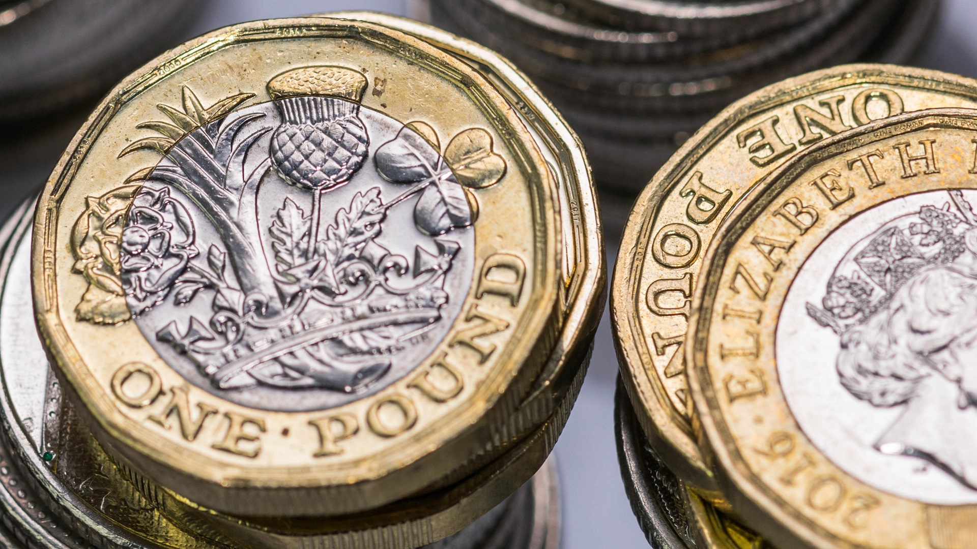 Stacks of British coins with one pound coins on top.