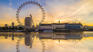 London Eye reflected on the river Thames during sunrise