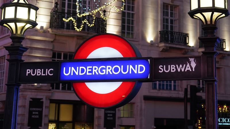 Illuminated London Underground roundel at night at a Tube station.