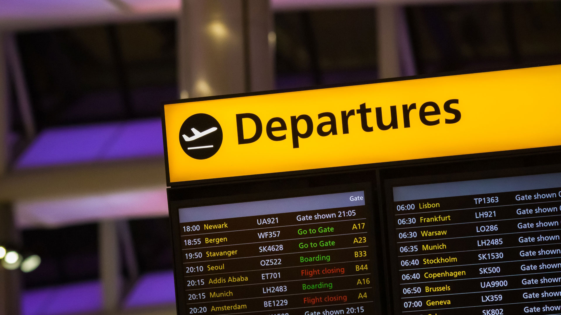 A photo of the digital departure board at London Heathrow Airport with a list of different flights, flight numbers and departure information