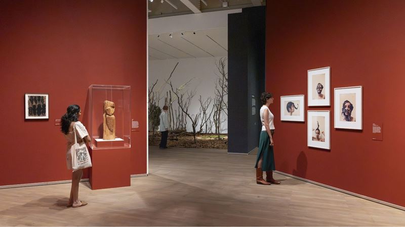 Ana Mendieta at Tate Modern. Image courtesy of Tate Modern © Tate (Yili Liu). Installations at Ana Mendieta at Tate Modern with two people looking up at the artwork.