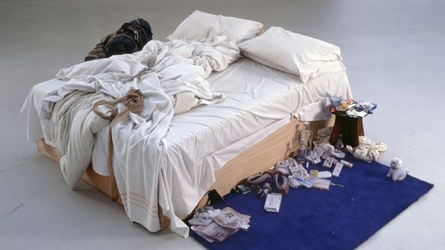 Tracey Emin My Bed featuring an unmade bed and a series of items surrounding it.