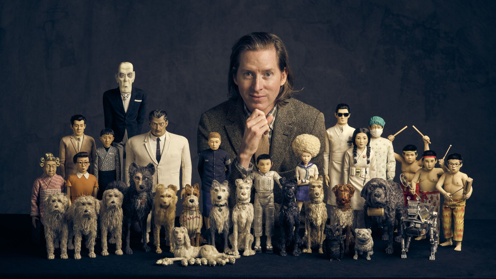 Delve into the work of one of the world's most creative directors at Wes Anderson: The Exhibition. Image courtesy of the Design Museum. A digital image of director wes anderson and figures of his famous film characters.
