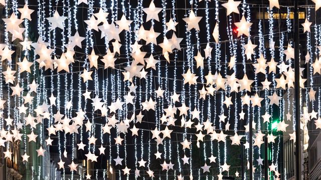 A close up photo of the festive star lights hanging above Oxford Street at night