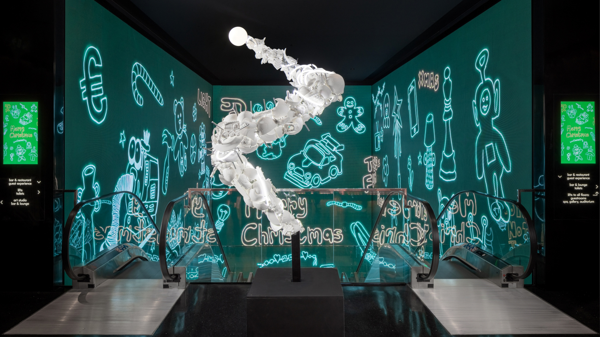 A photo of the Christmas tree on display at art'otel Hoxton, a large white sculpture made from shattered porcelain toys at the top of the hotel's escalators