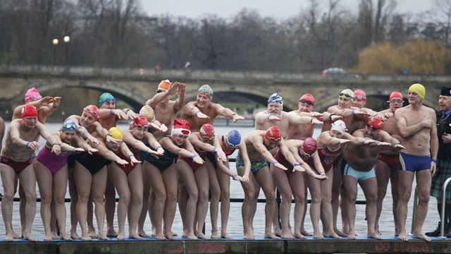 People in their swimming costumes about to jump into the water during The Christmas Day Peter Pan Cup in Hyde Park. 