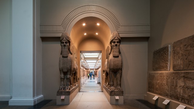 A corridor at the British Museums, with two sculptures gating it.