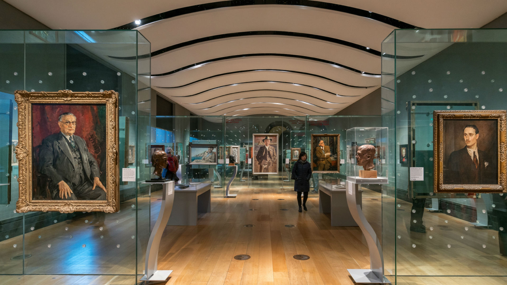 One of the rooms in the National Portrait Gallery with numerous portraits hanging on the walls.