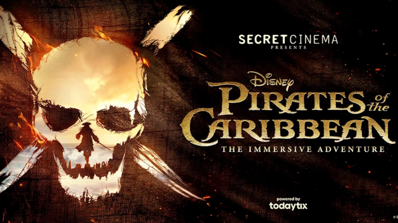 The publicity poster for Secret Cinema's Pirates of the Caribbean Immersive Experience, featuring a skull and crossbones on a black background.