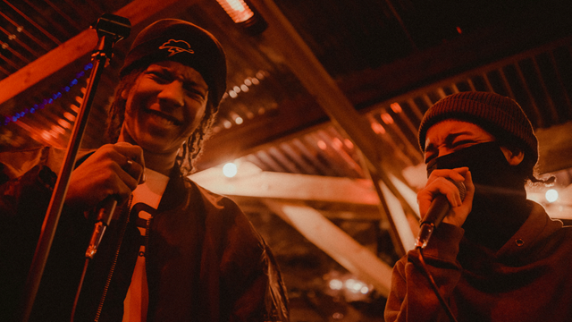 Two singers hold mics at Jumbi Orri Jam event
