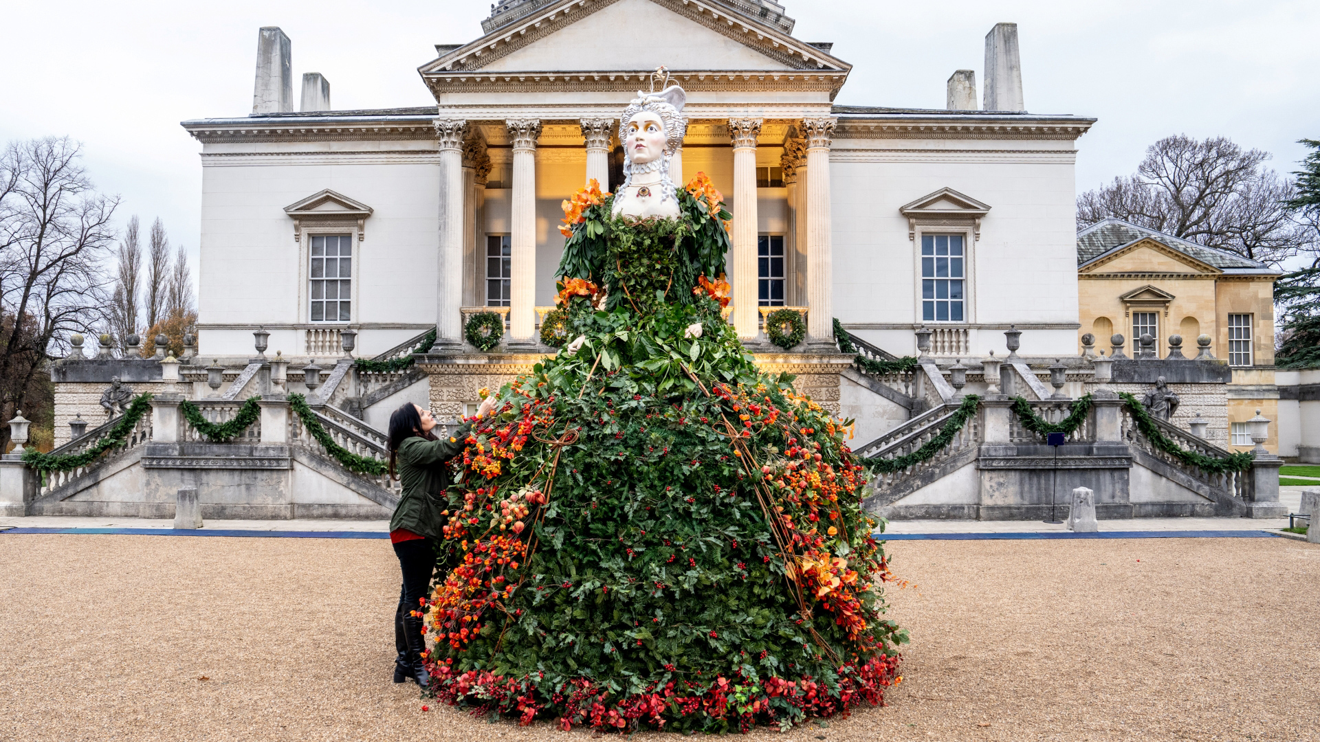 A photo of the statue in front of Chiswick House decorated with colourful plants and flowers in the shape of a giant Georgian dress