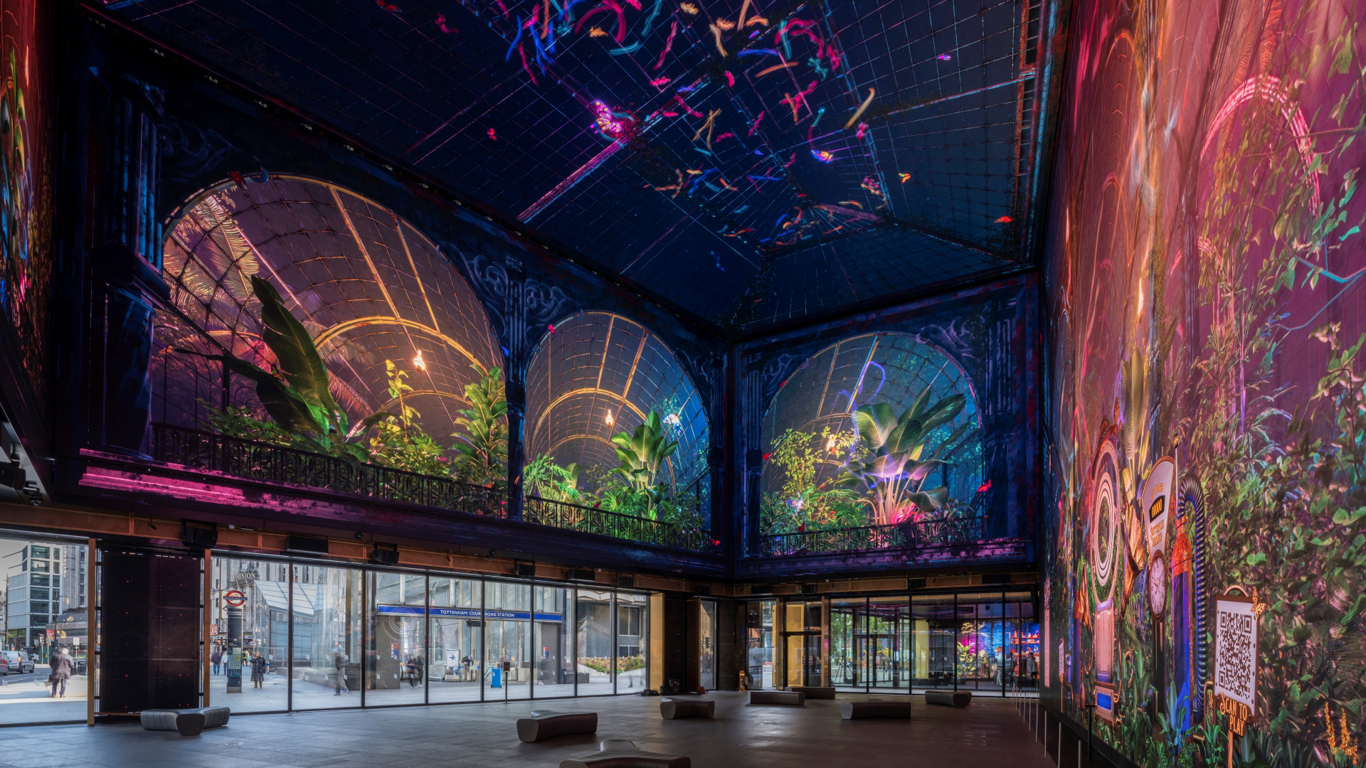 A photo of the Now Building at Outernet with multicoloured butterfly artwork across the walls and ceiling