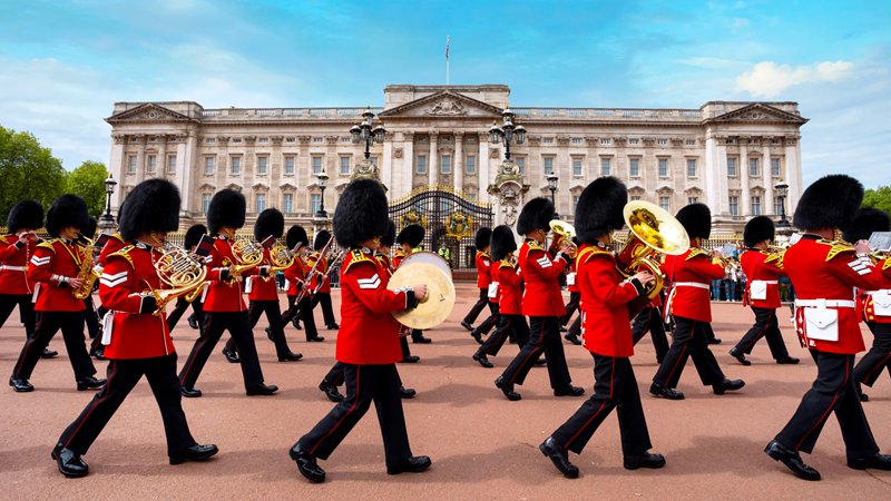 Band marches in front of Buckingham Palace during Changing the Guard