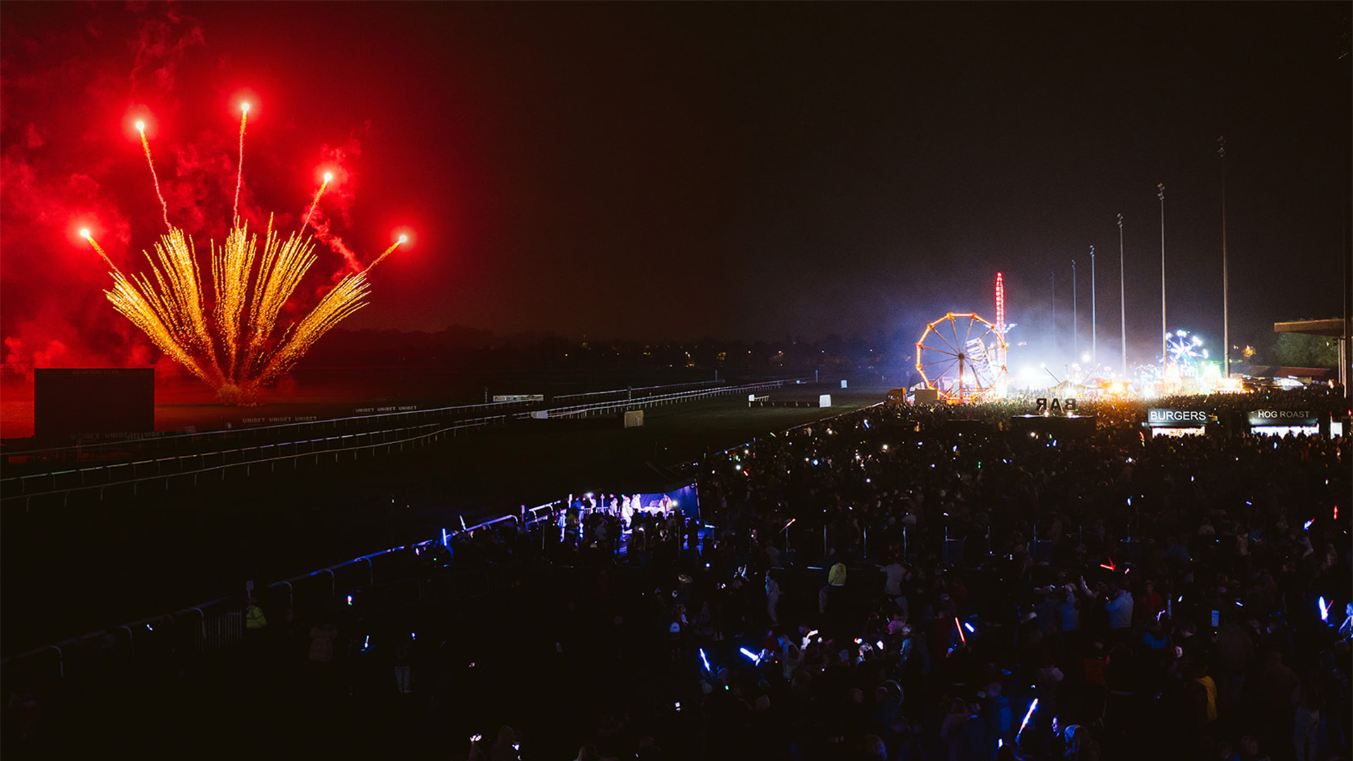A red firework display at Kempton Park Racecourse