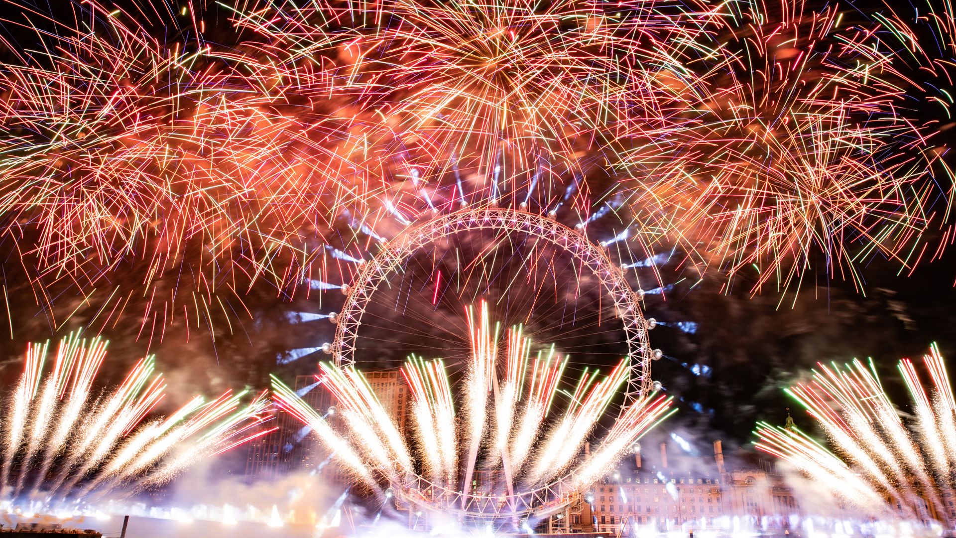 The London Eye surrounded by red fireworks on new years eve