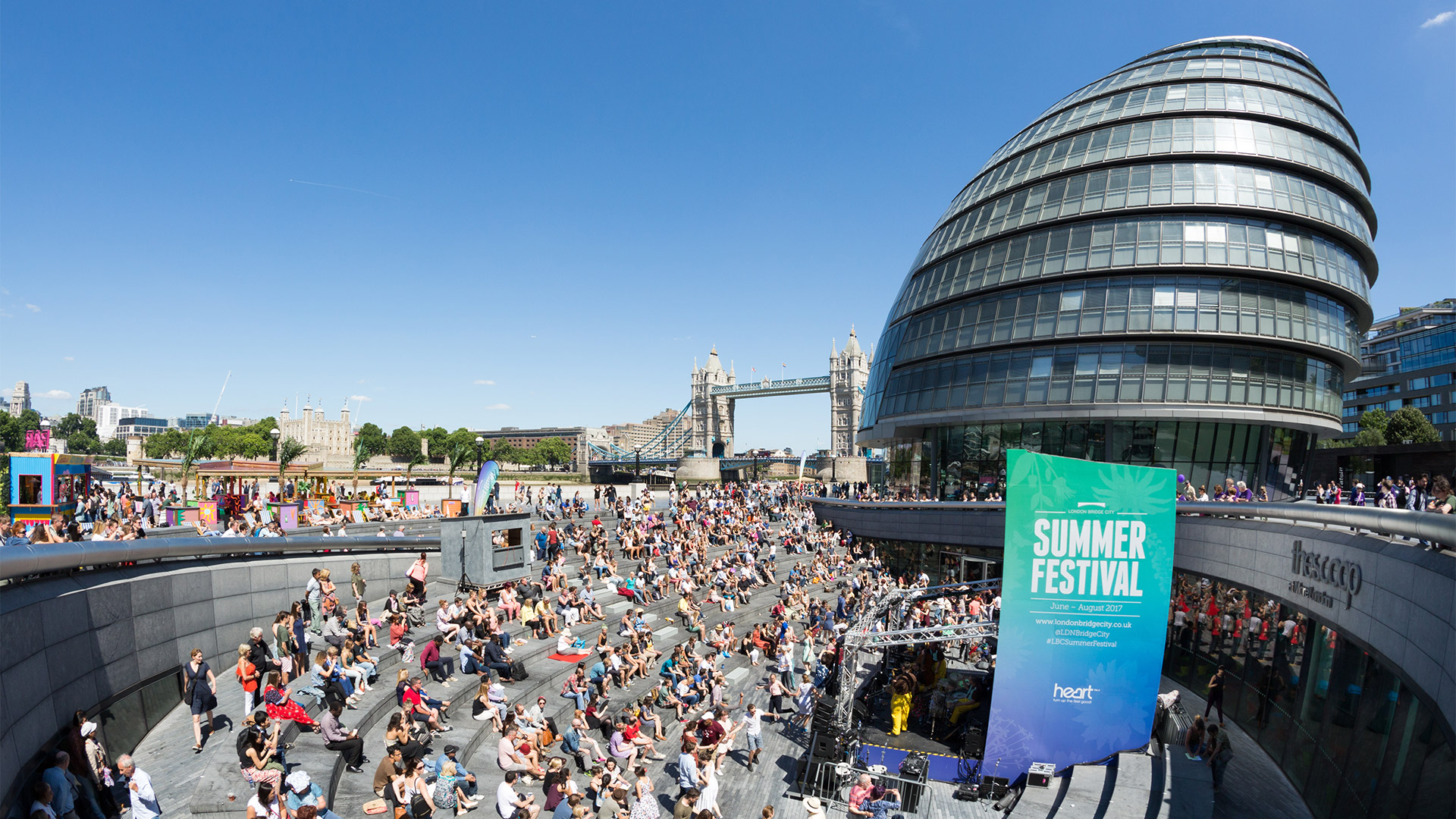 Crowds watch a performance during the Summer by the River festival at The Scoop.