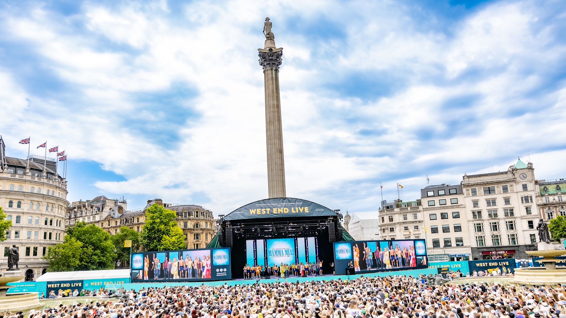 A crowd of people in Trafalgar Square look at the stage in front of Nelson's Column, during a performance from Mamma Mia! at West End Live.