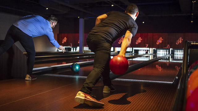 Two men bowling at All Star Lanes bowling alley in London.