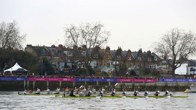 Oxford and Cambridge boat crews racing past crowds in London