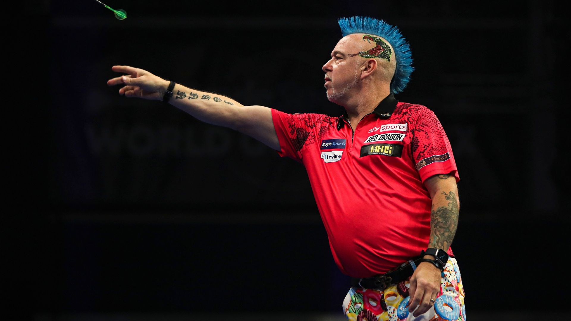 Peter "Snakebite" Wright brightens up every darts stage with his eccentric outfits. Photo credit: PDC. Peter "Snakebite" Wright brightening up the darts stage with his eccentric outfits including a blue mohawk and donut trousers.