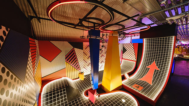 A neon lit, pop art inspired crazy golf obstacle at Birdies