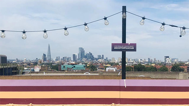 Yoga with a view from the rooftop of the Bussey Building at Yogarise Peckham © Yogarise. Image courtesy of Yogarise Views of the London skyline from a rooftop on a sunny day.