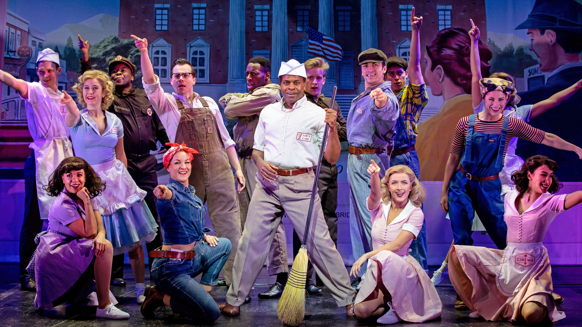 The cast of Back to the Future stands on the stage of the Adelphi Theatre.