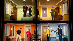 The cast of the comedy about spies in a doll house-style set. 