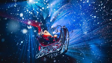 Santa stuns theatregoers in ELF The Musical by flying his sleigh over the audience, much to their delight. Photo credit: Matt Crockett.